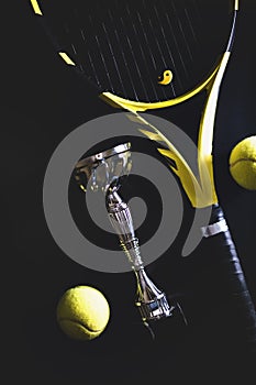Sport fitness equipment. Top view tennis racquet balls and silver cup