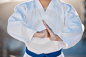 Sport, fitness and fighting with a karate man in gi, training in the city on a blurred background. Exercise, discipline
