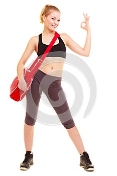 Sport. Fitness girl with gym bag showing ok hand sign