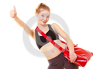 Sport. Fitness girl with gym bag showing thumb up