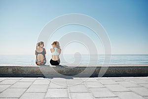 Sport fitness girls relaxing after training outdoor.