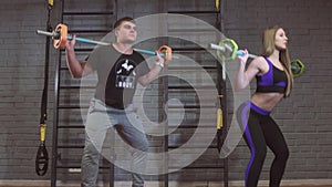 Sport, fitness, lifestyle and people concept - man and woman with barbell exercising in gym