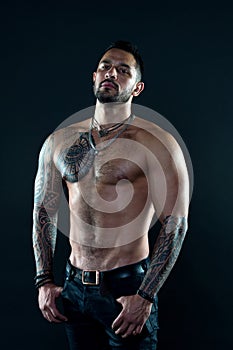 Sport and fitness. Masculinity. Muscular torso. Tempting glance. Bearded man with tattooed torso. Macho sexy bare torso