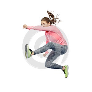 Happy sporty young woman jumping in fighting pose