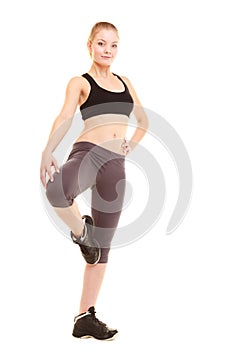 Sport. fitness sporty blonde girl stretching leg isolated