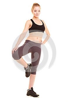 Sport. fitness sporty blonde girl stretching leg isolated