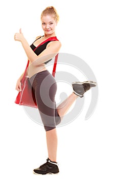 Sport. Fitness sporty girl with gym bag showing thumb up