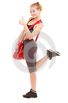 Sport. Fitness sporty girl with gym bag showing thumb up