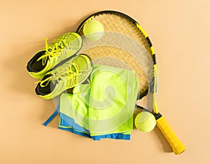 Sport, fitness, tennis, healthy lifestyle, sport stuff. Tennis racket, lime trainers, tennis ball, lime athletic shorts. Flat lay,
