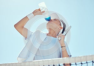 Sport, fitness and tennis man drinking water after workout, training game or health exercise on court. Wellness, sports