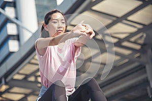 Sport Fitness Woman stretching body exercise in modern city wear wellness sportswear outside. Young woman workout outdoor