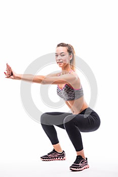 Sport fitness woman, young healthy girl doing squat exercises, full length portrait over white background