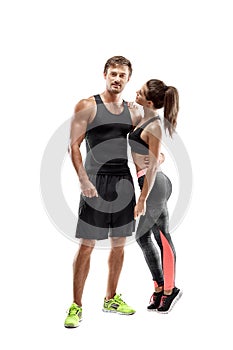 Sport, fitness, workout concept. Fit couple, strong muscular man and slim woman posing on a white background