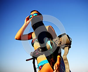 Sport girl in bikini on the beach near the sea, sunset time, golden hour light, watersport lifestyle