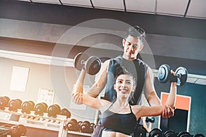 Sport girl doing weight exercises working with heavy dumbbells