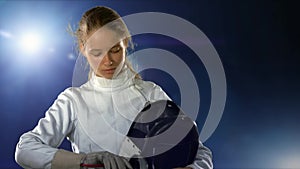 Sport girl fencer with epee before competition preparing for battle