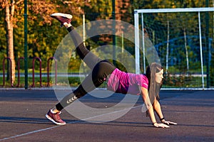 Sport girl. The girl is doing fitness exercises. Beautiful young sports woman doing exercises. A woman is training on a sports