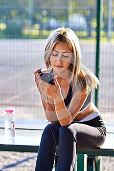 Sport girl. The girl is doing fitness exercises. Beautiful young sports woman doing exercises. A woman is training on a sports fie