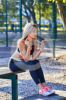 Sport girl. The girl is doing fitness exercises. Beautiful young sports woman doing exercises. A woman is training on a sports fie