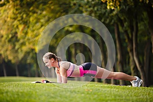 Sport girl making exercises outdoors.