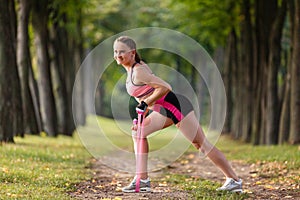 Sport girl making exercises outdoors.