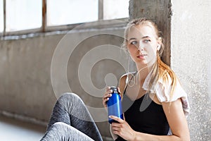 Sport Girl Sitting And Holding Bottle