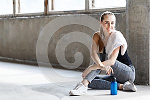 Sport Girl Sitting And Smiling In The Gym