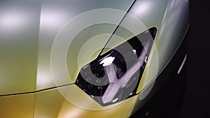 Sport green car headlight. Automobile tuning. Luxury coupe.