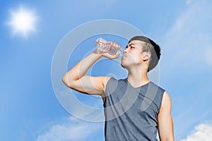 Sport and healthy concept : Thirsty athlete drinking water after