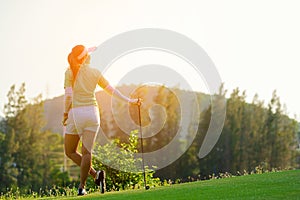 Sport Healthy. Golfer asian sporty woman relax on fairway for the put golf ball on the green golf evening time in vacations day.