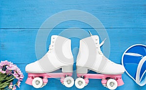 Sport, healthy lifestyle, roller skating background. White roller skates and blue visor hat. Flat lay, top view.