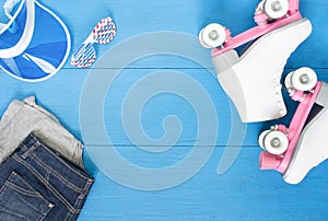 Sport, healthy lifestyle, roller skating background. White roller skates, clothing set, sunglasses and blue visor hat