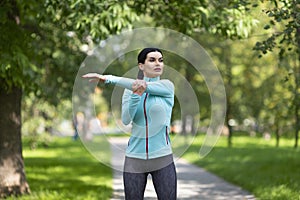 Sport and healthy lifestyle - woman strething hand muscles before workout.