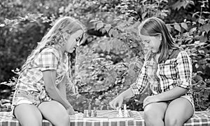 Sport and hobby concept. Little girls play chess. Sisters playing chess. Smart children. Early childhood development