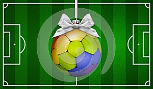 Sport for human rights concept, merry Christmas gift greeting card with soccer ball colored in rainbow colors, on football pitch