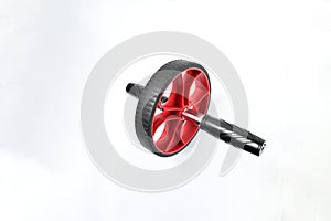 Sport item object, balck and red ab roller wheel on white background with space for text. Essential fitness tool. Home gym