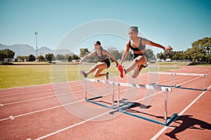 Sport, jump and women runner doing hurdles on stadium track, athlete running race and fitness training outdoor. Practice