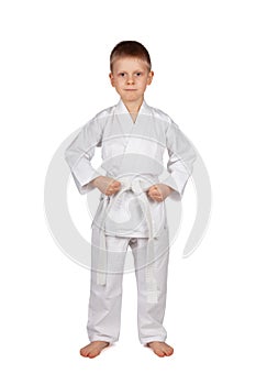 Sport is karate. Serious boy in white kimono isolated on white background