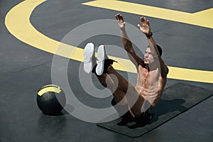 Sport man doing abs exercise, fitness workout outdoors at gym