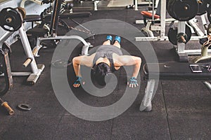 Sport man doing push ups exercise in gym. Workout concept. Fitness concept