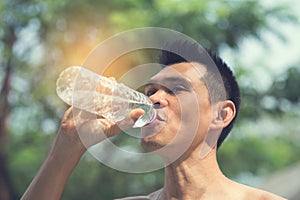 Sport man drinking a bottle of water