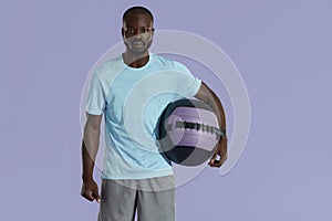 Sport man in fashion sportswear with med ball studio portrait