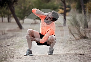 Sport man injured when exercising or running holding his knee screaming in pain