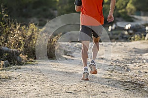 Sport man with ripped athletic and muscular legs running uphill