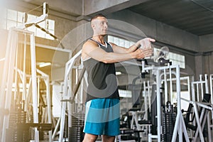 Sport man stretching hand for warming up befor doing exercises training,Cross fit body muscular workout in the gym