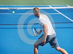 Sport, man and tennis on court with fitness, competition and performance outdoor with serve and energy. Athlete, player