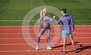 sport man and woman fitness partners celebrate team win with gesture of shake hand after exercising or compete in