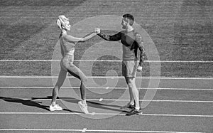 sport man and woman fitness partners celebrate team win with gesture of shake hand after exercising or compete in