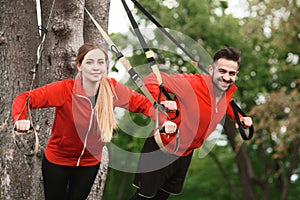 Sport man and woman training in park