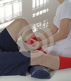 Sport Massage Therapist working on calf muscle